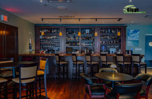The District Biggs Construction Company, Inc. Custom Cabinetry Wood Bar, with Mirrors and Glass Shelves, Custom Wood Bar and custom wainscoting Bar front. Custom Stained Wood Wine Storage, Wine Glass storage