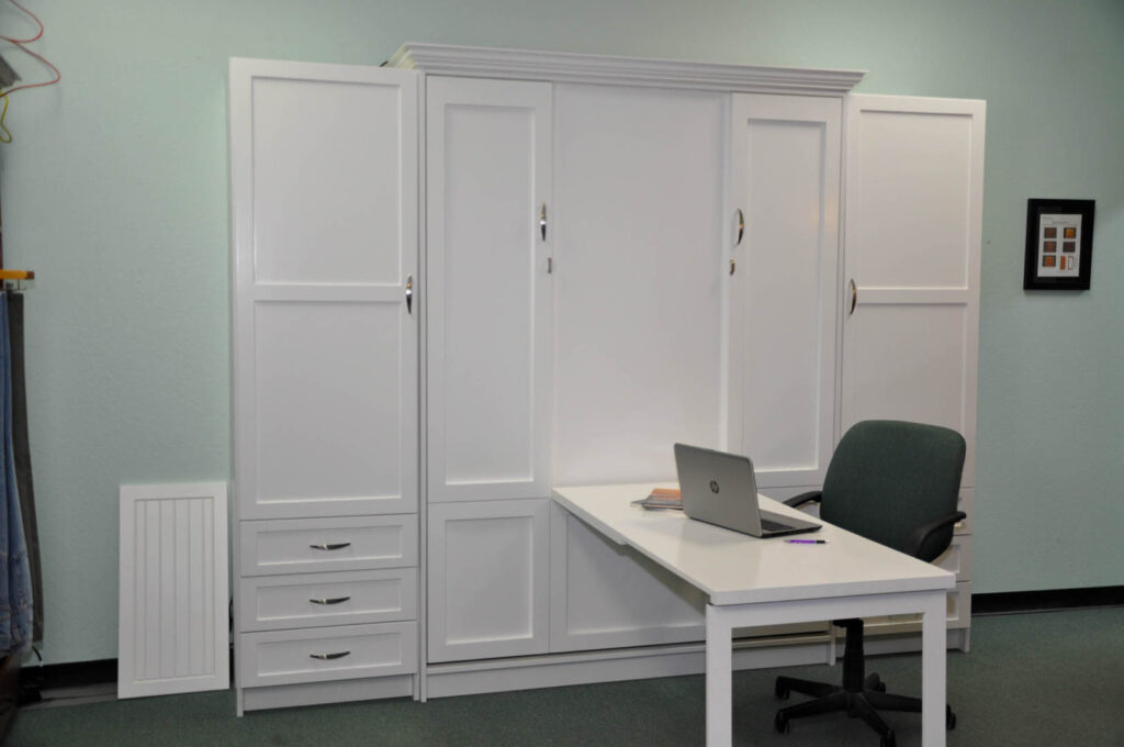 Patrick Murphy Bed folded up with its fold-down desk in use, built for a Gulf Breeze customer