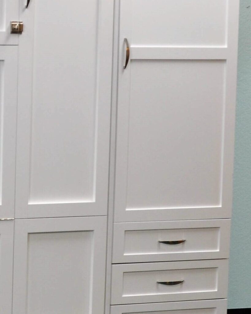 Close-up of a Patrick Murphy Bed side unit: painted panel door and drawers with brushed nickel pulls